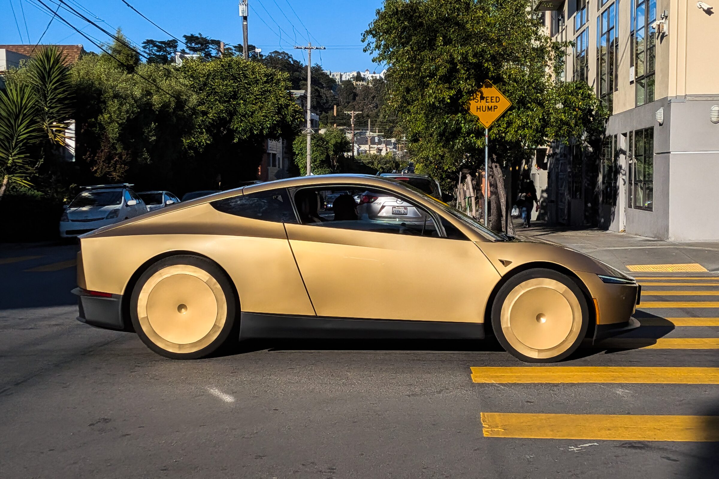 A Tesla Cybercab moving across a San Francisco street.